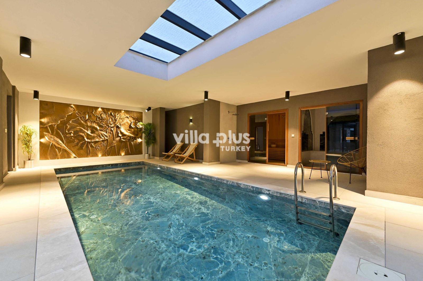 a villa with indoor and heated pool